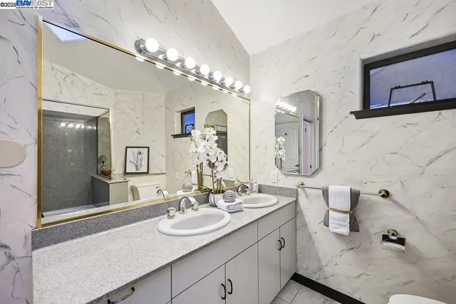 a white toilet sitting next to a bathroom sink
