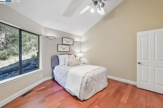 a dining room with furniture a chandelier and wooden floor