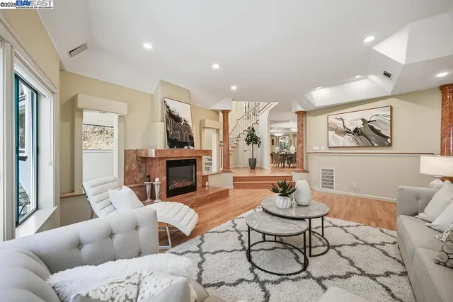 a living room with fireplace furniture and a chandelier