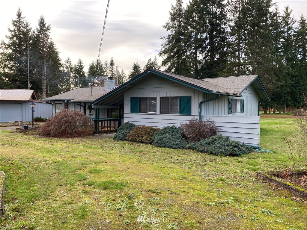 19147 Old Highway 99 Southwest Rochester, WA 98579 - Photo 1 of 27 a front view of a house with a yard