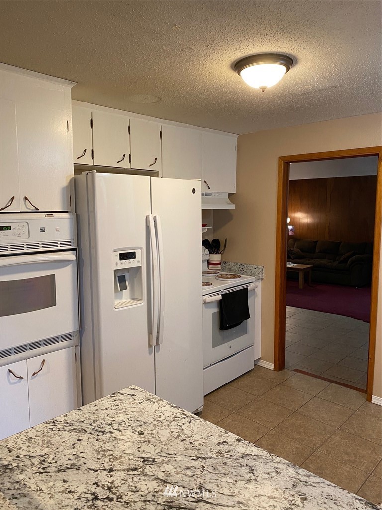 19147 Old Highway 99 Southwest Rochester, WA 98579 - Photo 12 of 27 a kitchen with stainless steel appliances kitchen island a refrigerator sink and stove