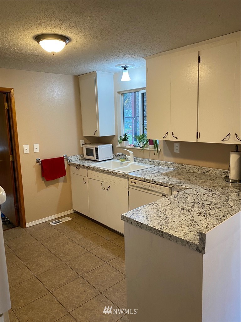19147 Old Highway 99 Southwest Rochester, WA 98579 - Photo 13 of 27 a kitchen with stainless steel appliances granite countertop a sink stove and cabinets