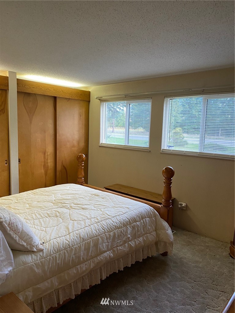 19147 Old Highway 99 Southwest Rochester, WA 98579 - Photo 21 of 27 a bedroom with a bed and a window