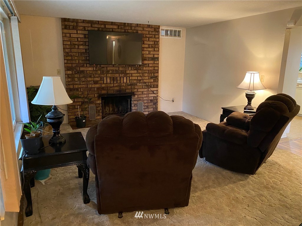 19147 Old Highway 99 Southwest Rochester, WA 98579 - Photo 7 of 27 a living room with furniture and a fireplace
