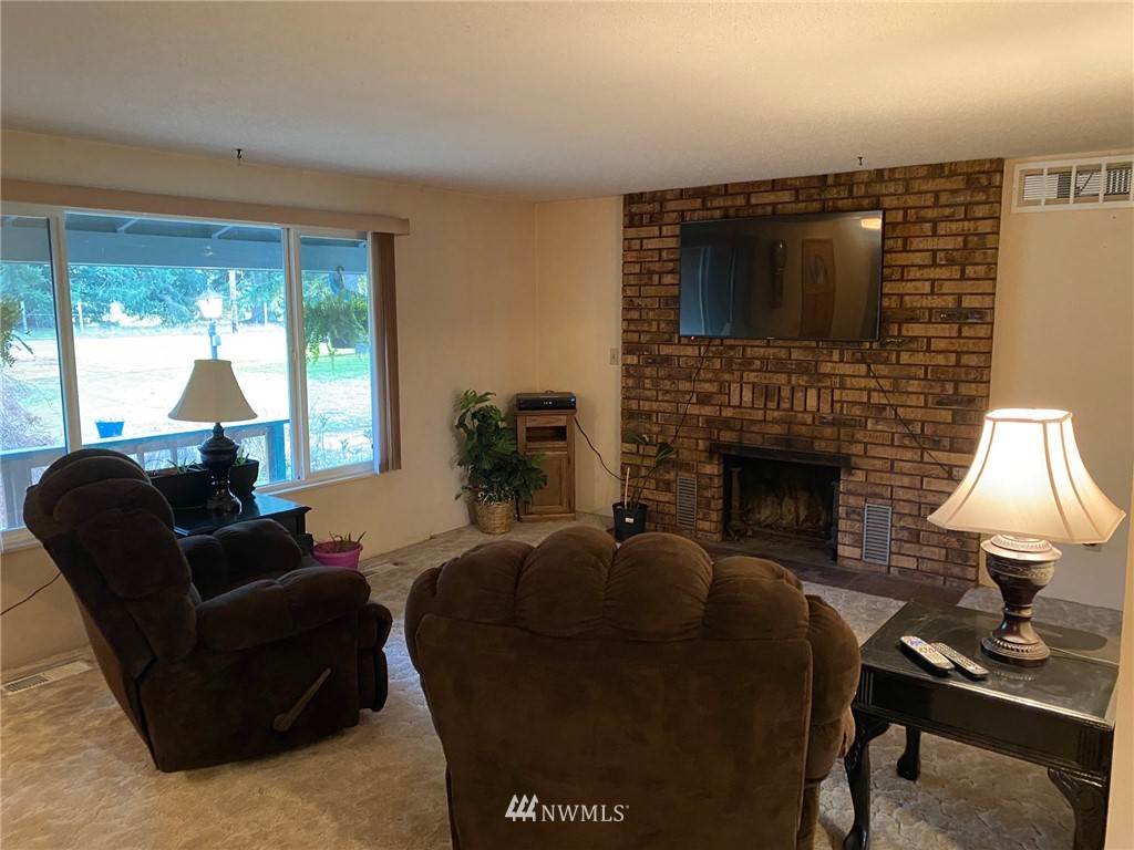 19147 Old Highway 99 Southwest Rochester, WA 98579 - Photo 8 of 27 a living room with furniture and a fireplace
