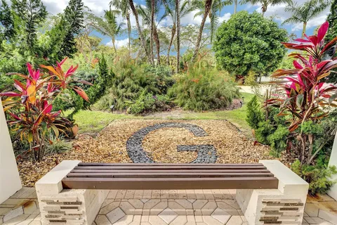 a view of a livingroom with furniture hardwood floor and a large window