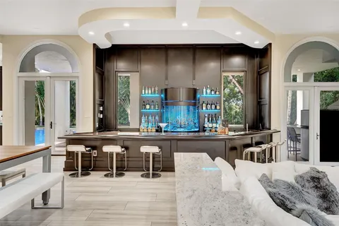 a open kitchen with granite countertop a stove a sink and wooden floor