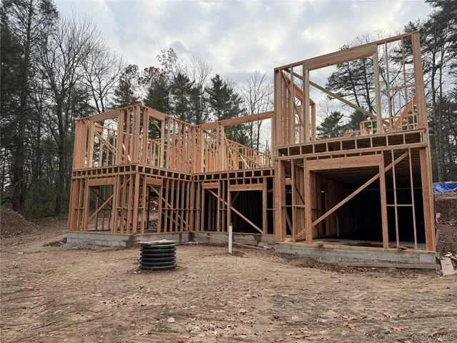 a large white building with a large window and wooden fence