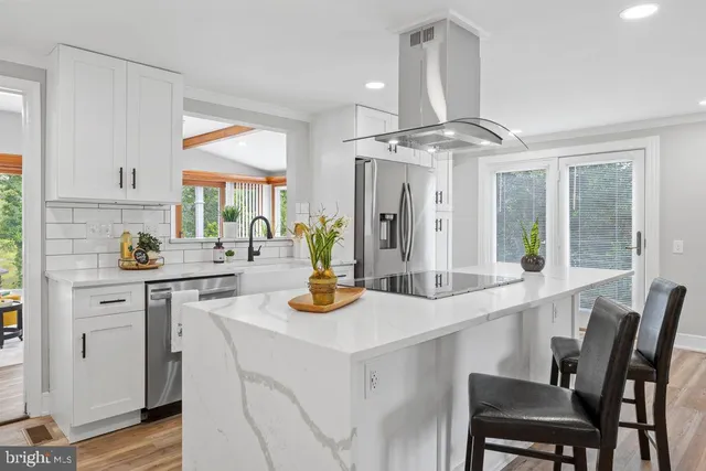 a kitchen with a table chairs stove and cabinets