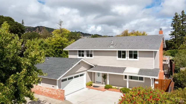a aerial view of a house next to a yard