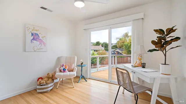 a living room with furniture and a potted plant