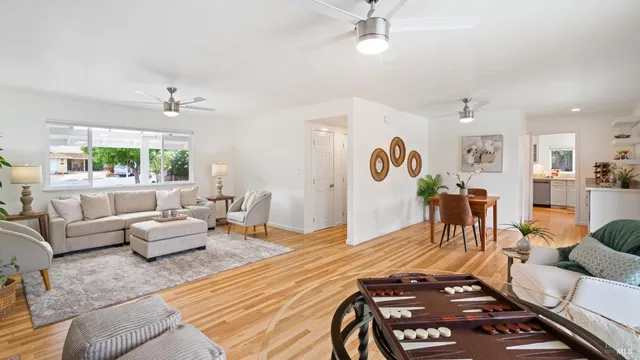 a living room with furniture and wooden floor