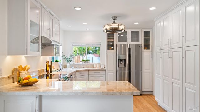 a kitchen with stainless steel appliances granite countertop a refrigerator and a sink