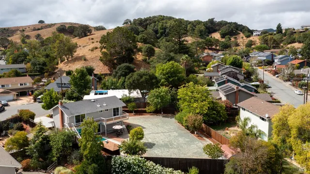 an aerial view of a house with yard swimming pool and mountain view