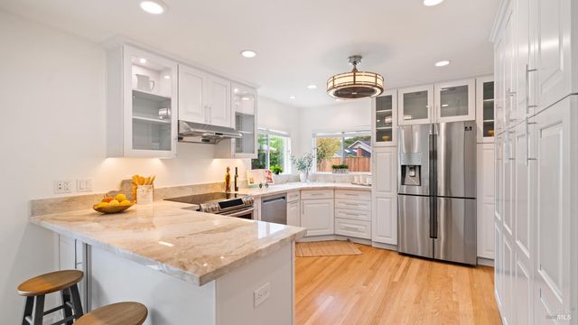 a kitchen with refrigerator a sink and cabinets