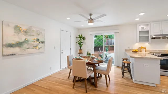 a view of a dining room with furniture window and wooden floor