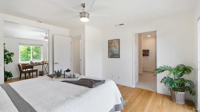 a bed room with a bed mirror and a window