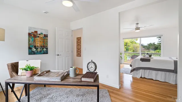 a view of a workspace with furniture and a window