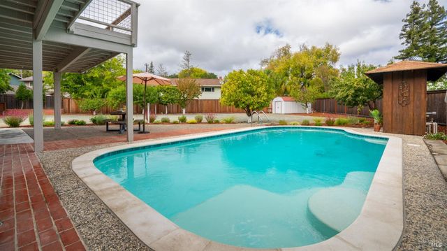 a view of a swimming pool with sitting area
