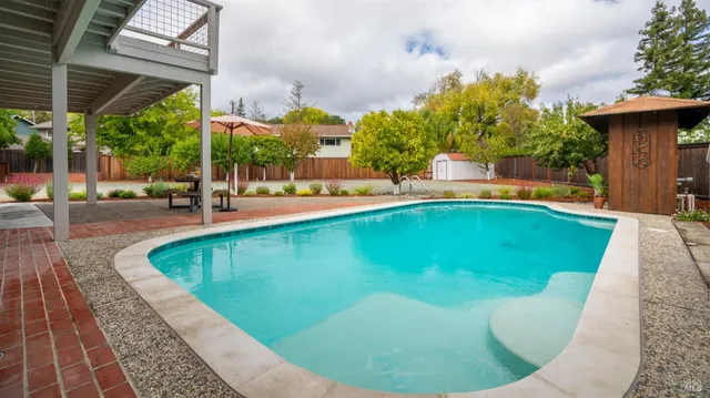 a view of a swimming pool with sitting area