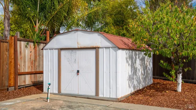 a backyard of a house with table and chairs