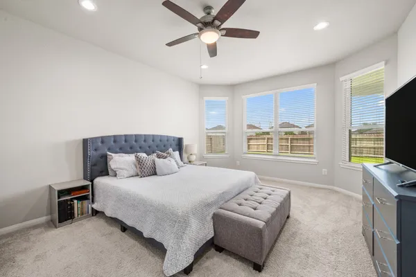 a bedroom with a large bed and a tv