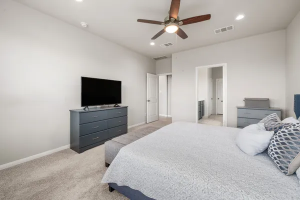 a bedroom with a bed and a flat screen tv