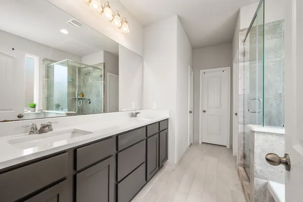 a bathroom with a double vanity sink mirror and double