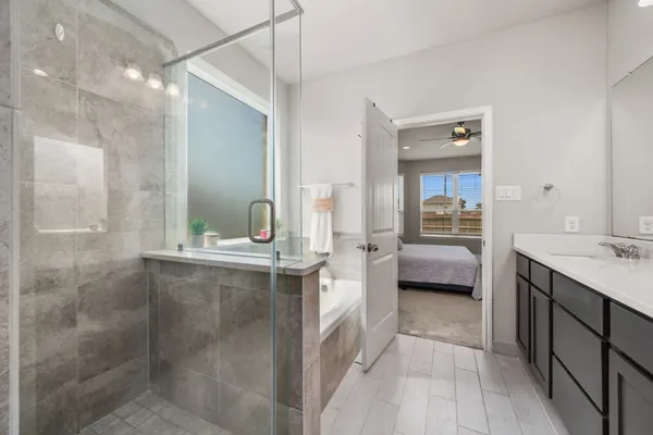 a en suite bathroom with a double vanity sink a mirror and a shower