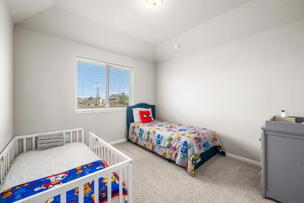 a bedroom with a bed and a dresser in it