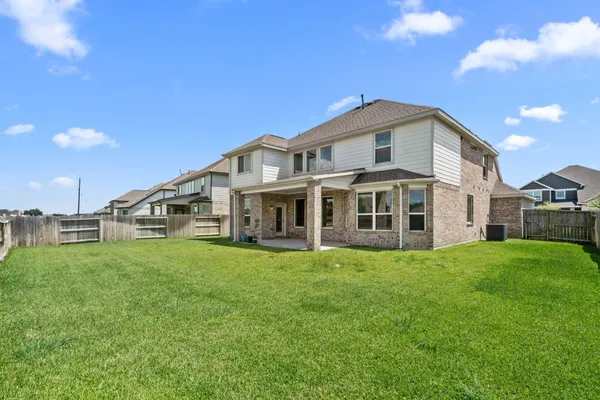 a big house with a big yard and large trees