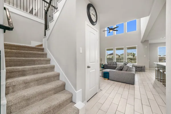 a view of entryway and hall with wooden floor