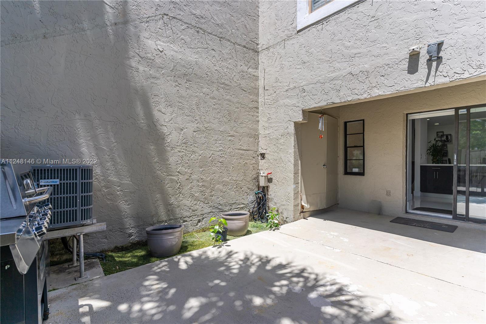 10505 Southwest 153rd Court, Unit 2 Miami, FL 33196 - Photo 22 of 39 a front view of a house with a yard
