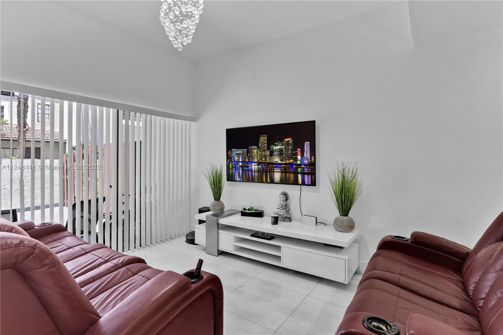 10505 Southwest 153rd Court, Unit 2 Miami, FL 33196 - Photo 24 of 39 a bedroom with furniture and a flat screen tv