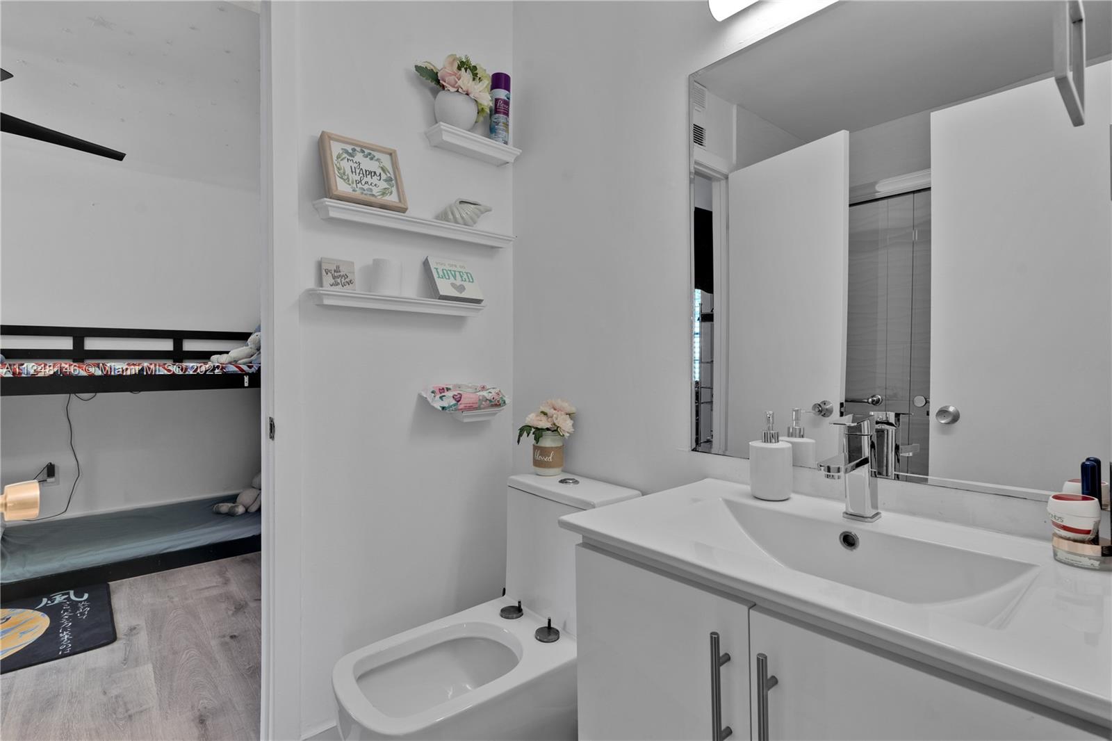 10505 Southwest 153rd Court, Unit 2 Miami, FL 33196 - Photo 36 of 39 a bathroom with a sink and a mirror