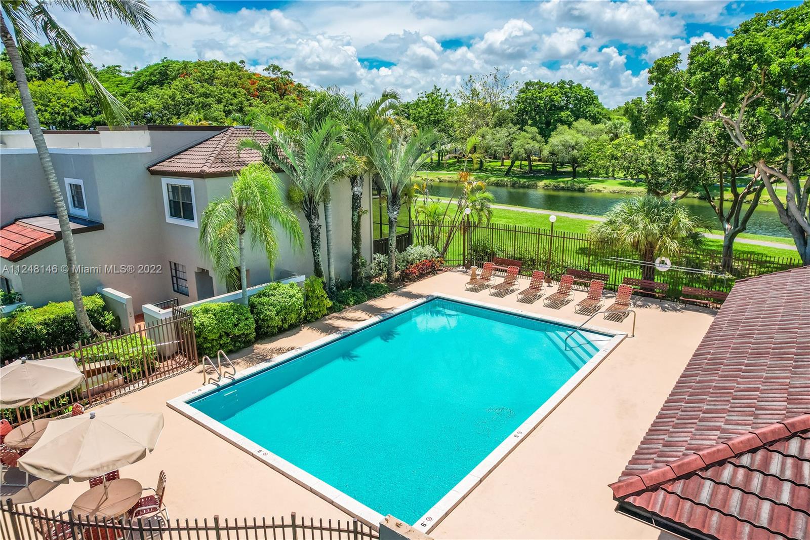 10505 Southwest 153rd Court, Unit 2 Miami, FL 33196 - Photo 9 of 39 a view of a swimming pool with a patio and a yard