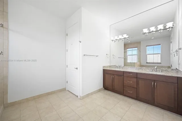 a bathroom with a granite countertop sink two mirror and a