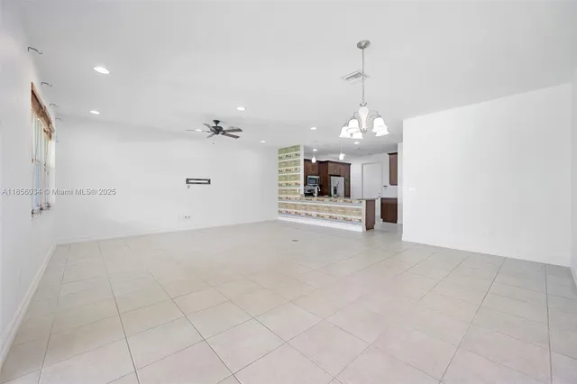 a view of a kitchen with a sink and a chandelier