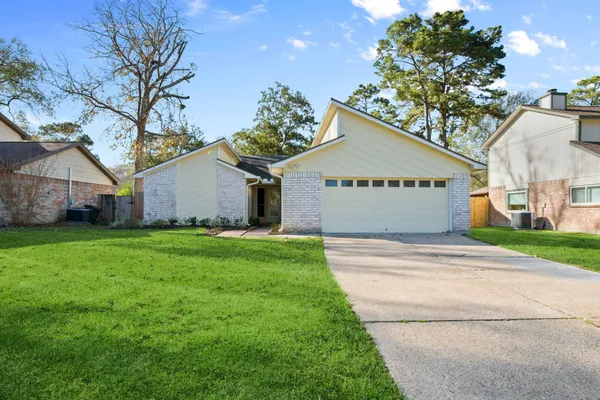 a front view of house with yard and green space