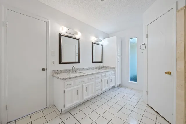 a bathroom with a granite countertop sink mirror and