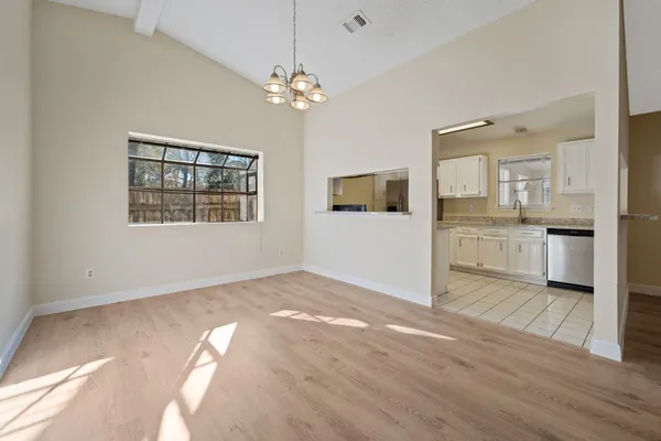 a view of a kitchen with wooden floor and a kitchen