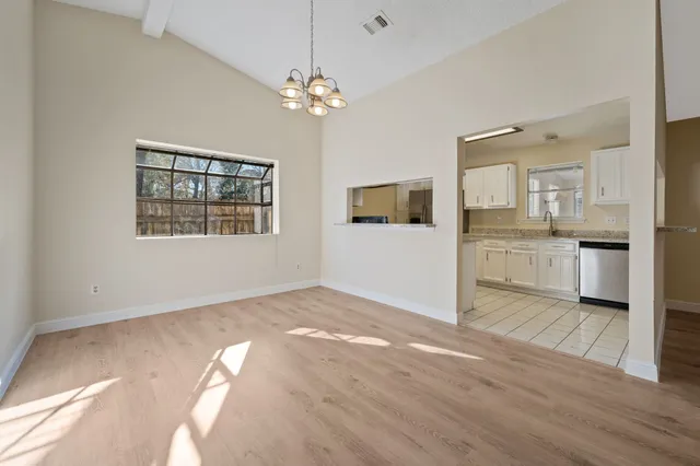 a view of a kitchen with wooden floor and a kitchen