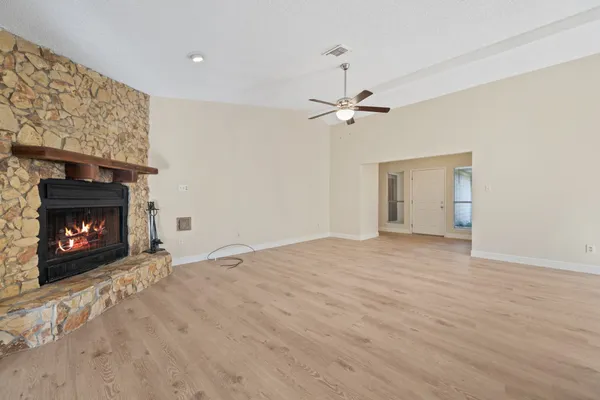 a view of an empty room with fire place and a fireplace