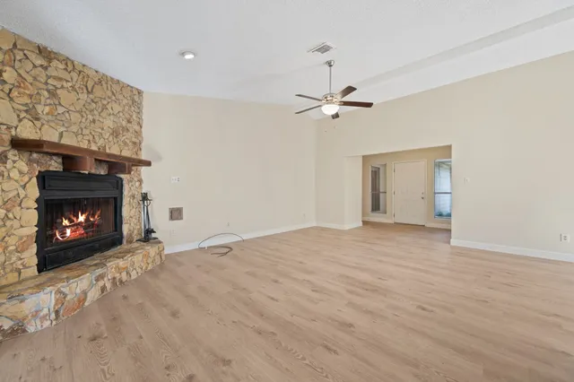 a view of an empty room with fire place and a fireplace