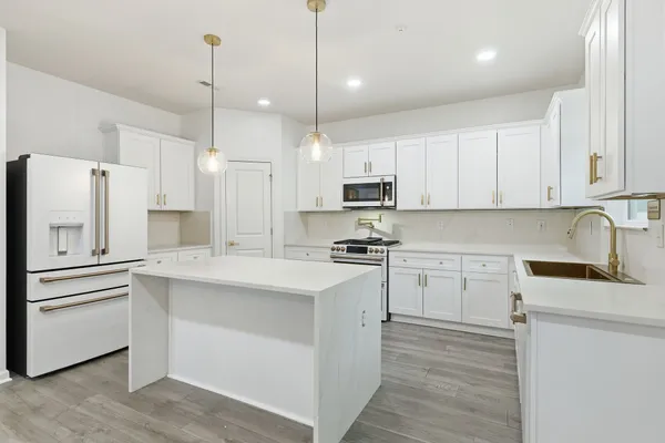 a kitchen with kitchen island white cabinets and white appliances