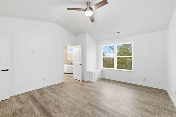 wooden floor in an empty room with a window