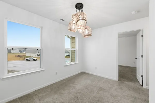 an empty room with a window and a ceiling fan