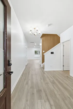 a view of a hallway with wooden floor