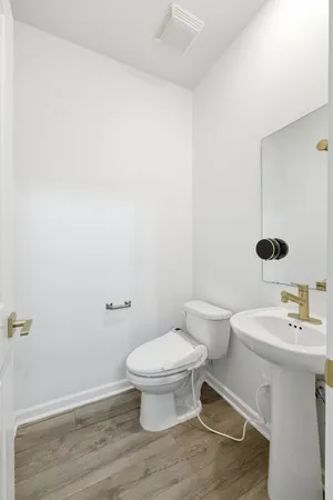 a bathroom with a toilet and a sink