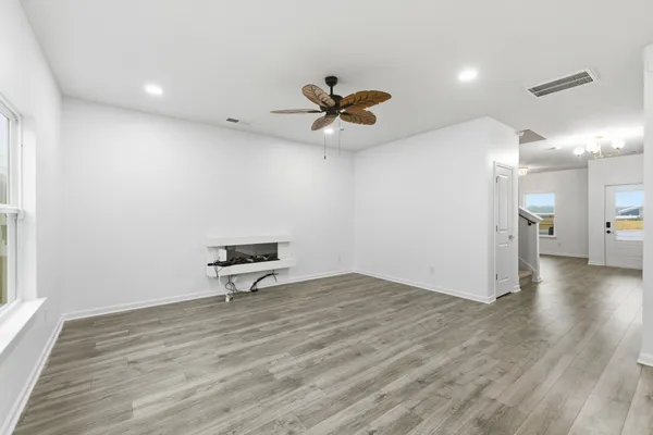 a view of a room with a sink and wooden floor